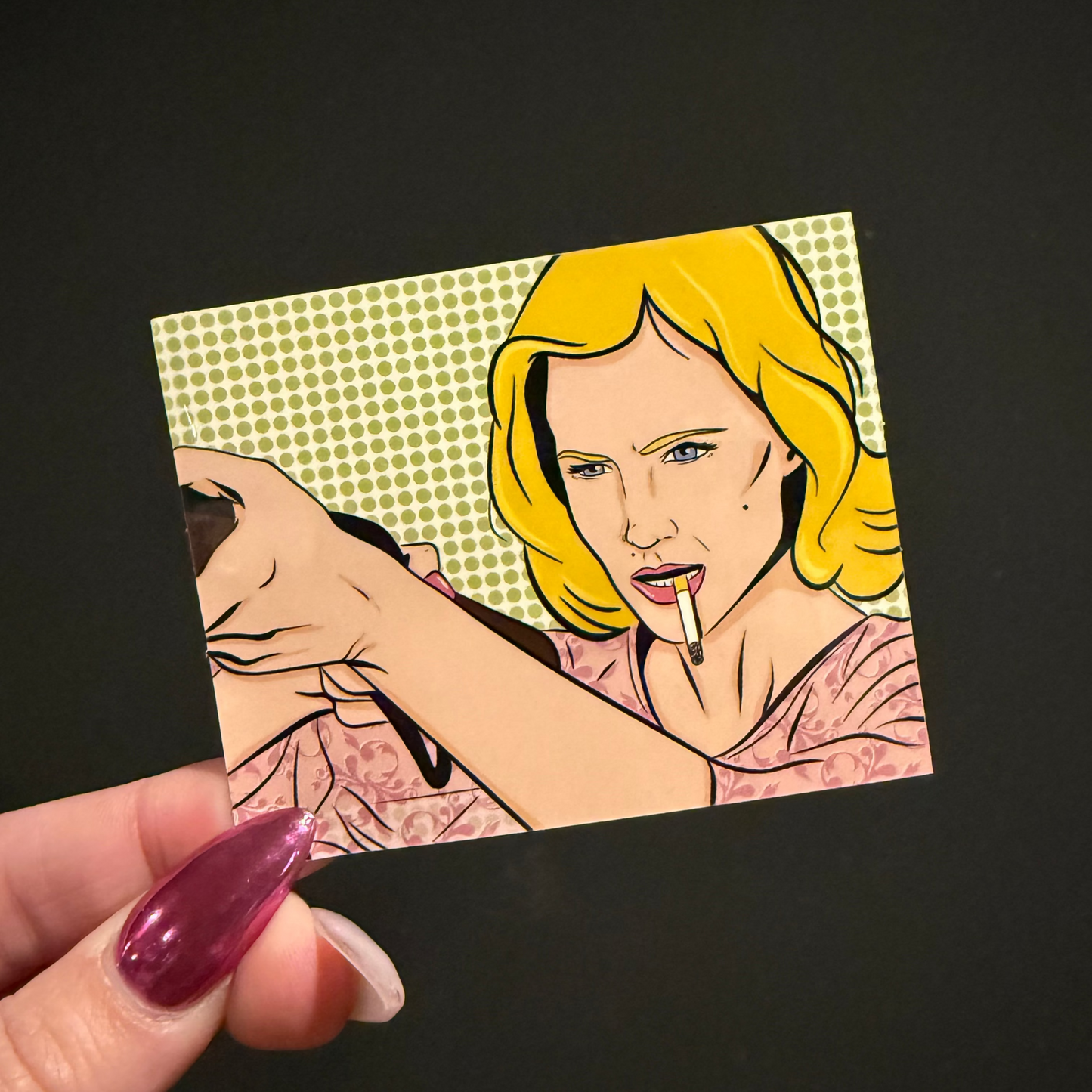 Cartoon-style illustration of a woman with yellow hair and a cigarette held by a hand on a black background.