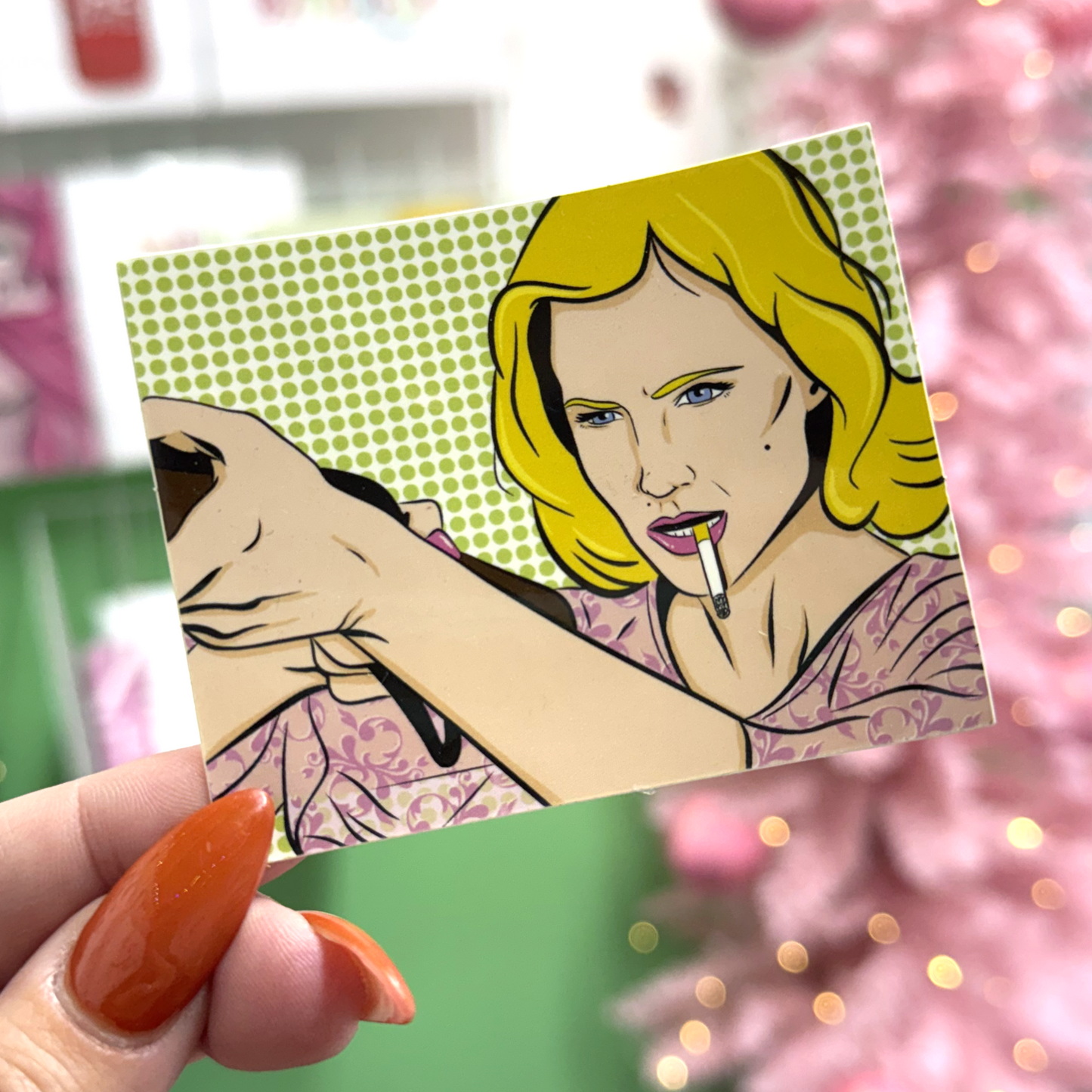 Comic-style illustration of a woman with a cigarette held by a hand, held by a person with orange nail polish.